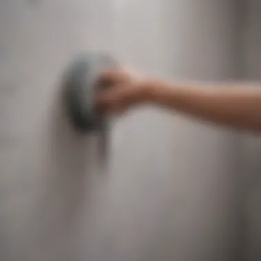 A close-up of tape being applied to a wall without damaging the paint