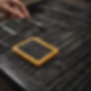 Person using a brush to clean a stove top grate