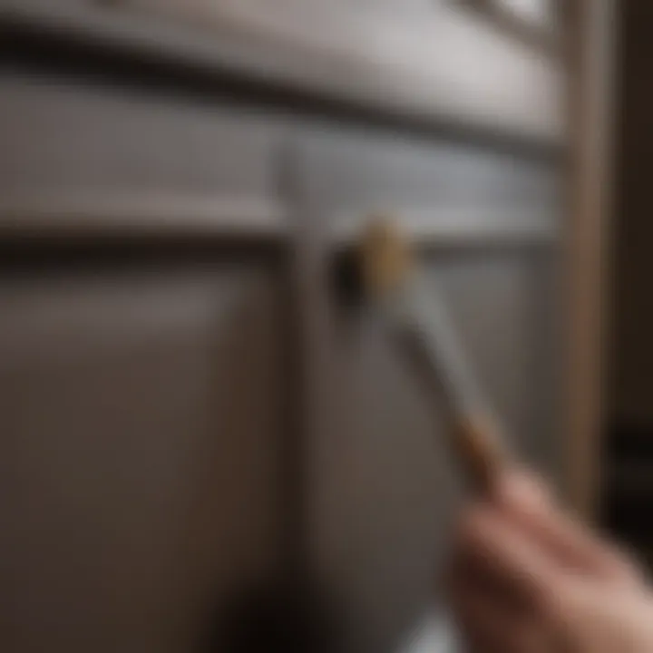 A close-up of a paintbrush applying a rich color on a cabinet door